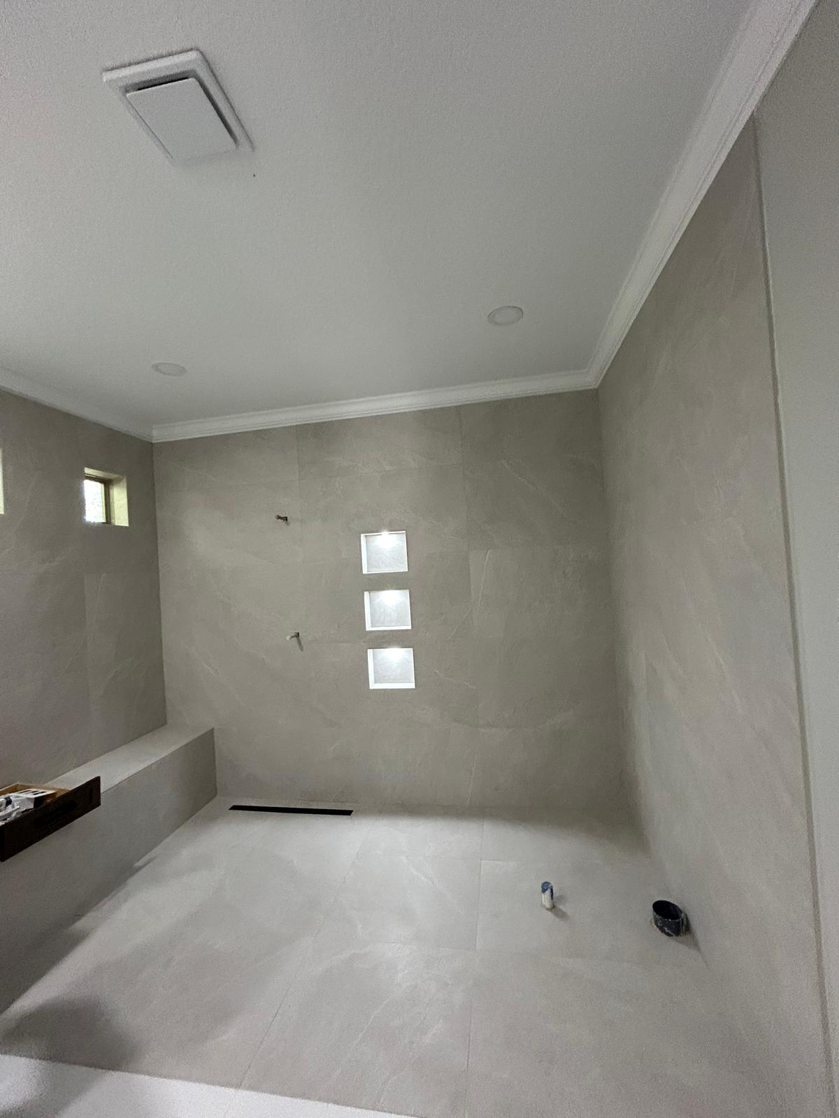 Bathroom finished with seamless large-format wall and floor tile
