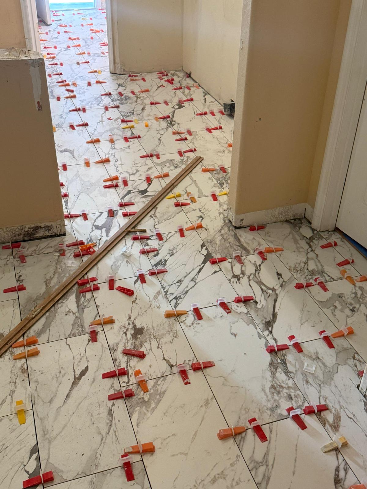 Continuous marble-look tile installation through an interior hallway